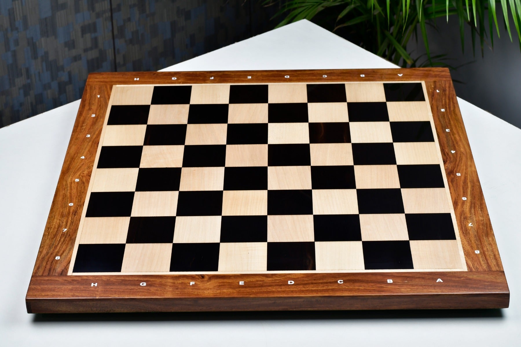 Ebony and maple sheesham border notation chess board at an angle
