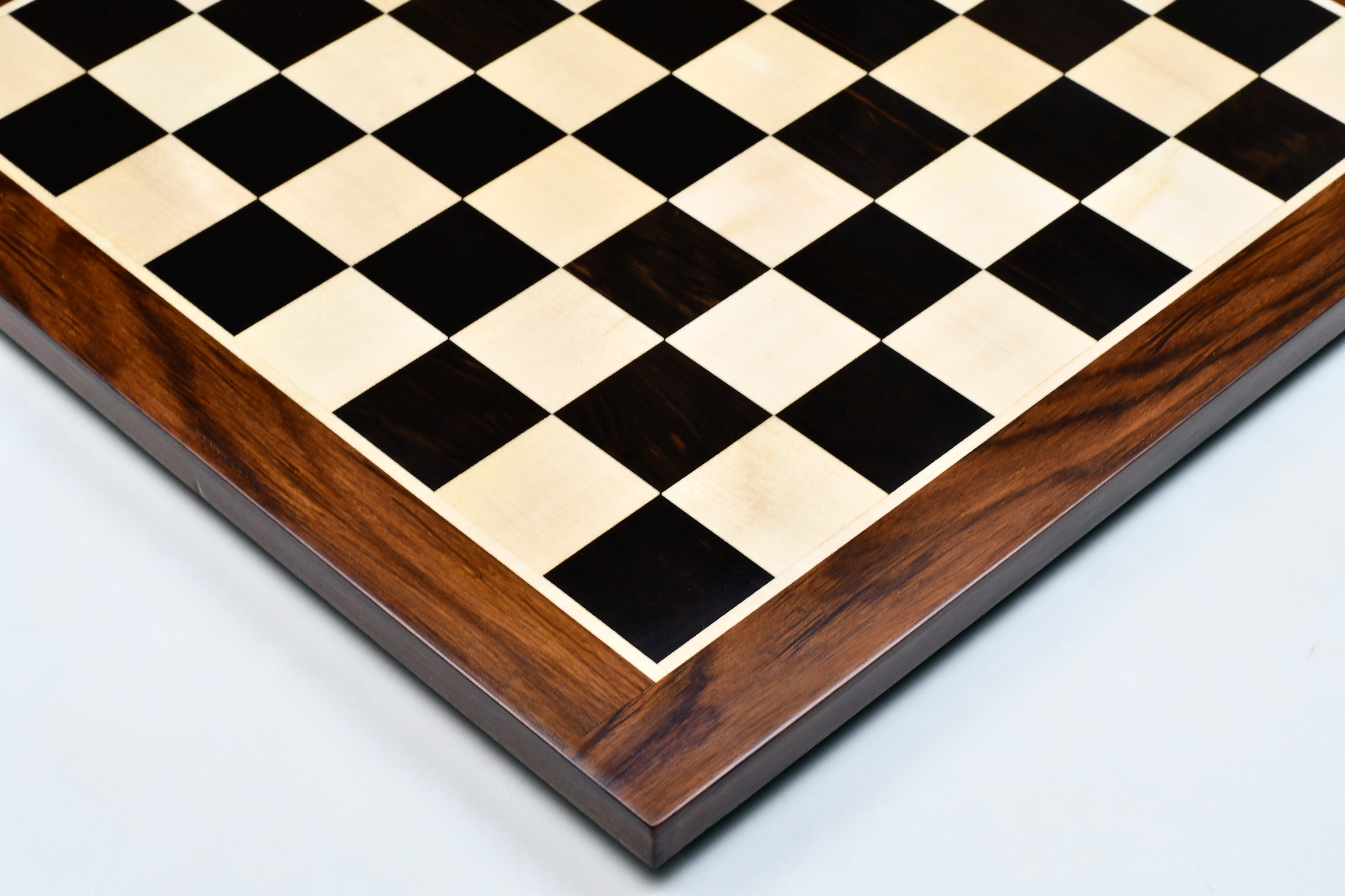 Ebony and maple sheesham border chess board at an angle