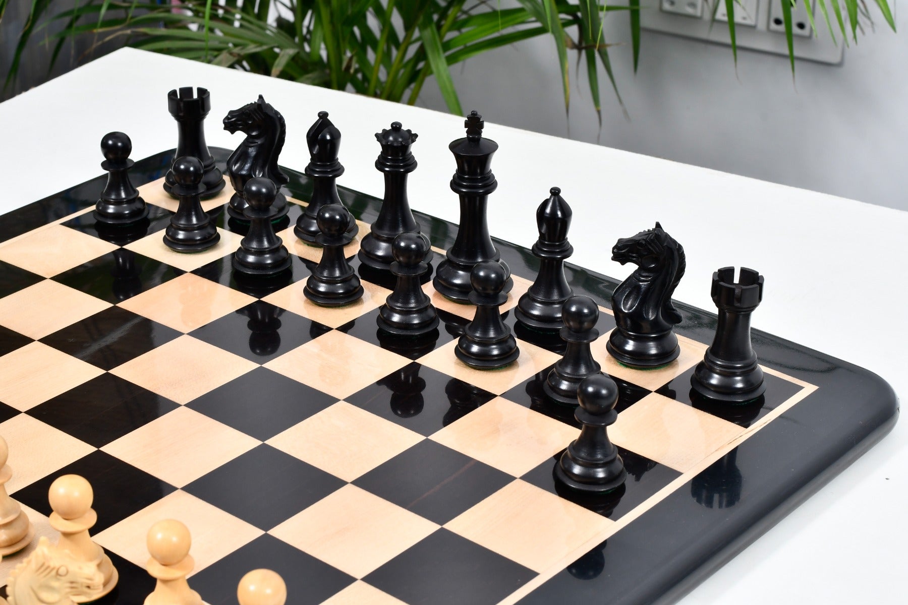 Fierce Knight ebonised boxwood chess set arranged on 55mm squares