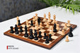 Ebonised chess pieces set up for play on the included 37cm sheesham and boxwood board