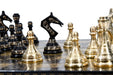 Brass metal chess set in shiny gold and black with a 35cm board