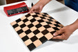 Folding ebony and maple chess board at an angle