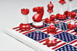Captain America chess set, 34 painted plastic pieces with two spare queens