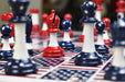 Red and blue superhero themed plastic chess set with board, Australia