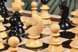 Ebonised chess pieces with a 107mm king and weighted felted bases