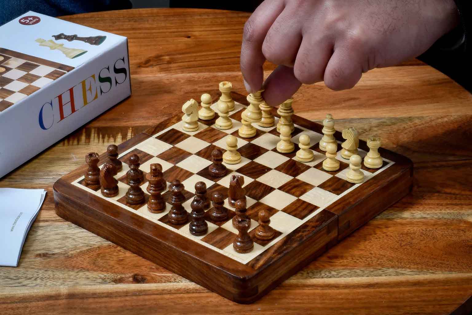 Sheesham and maple lacquered folding travel chess set viewed from above