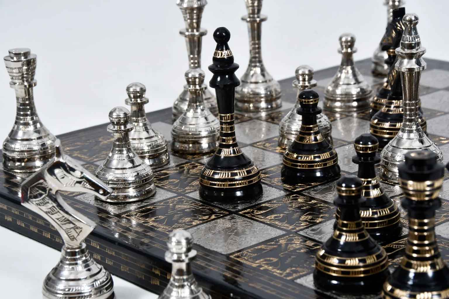 Shiny silver and black brass metal chess set for display and play
