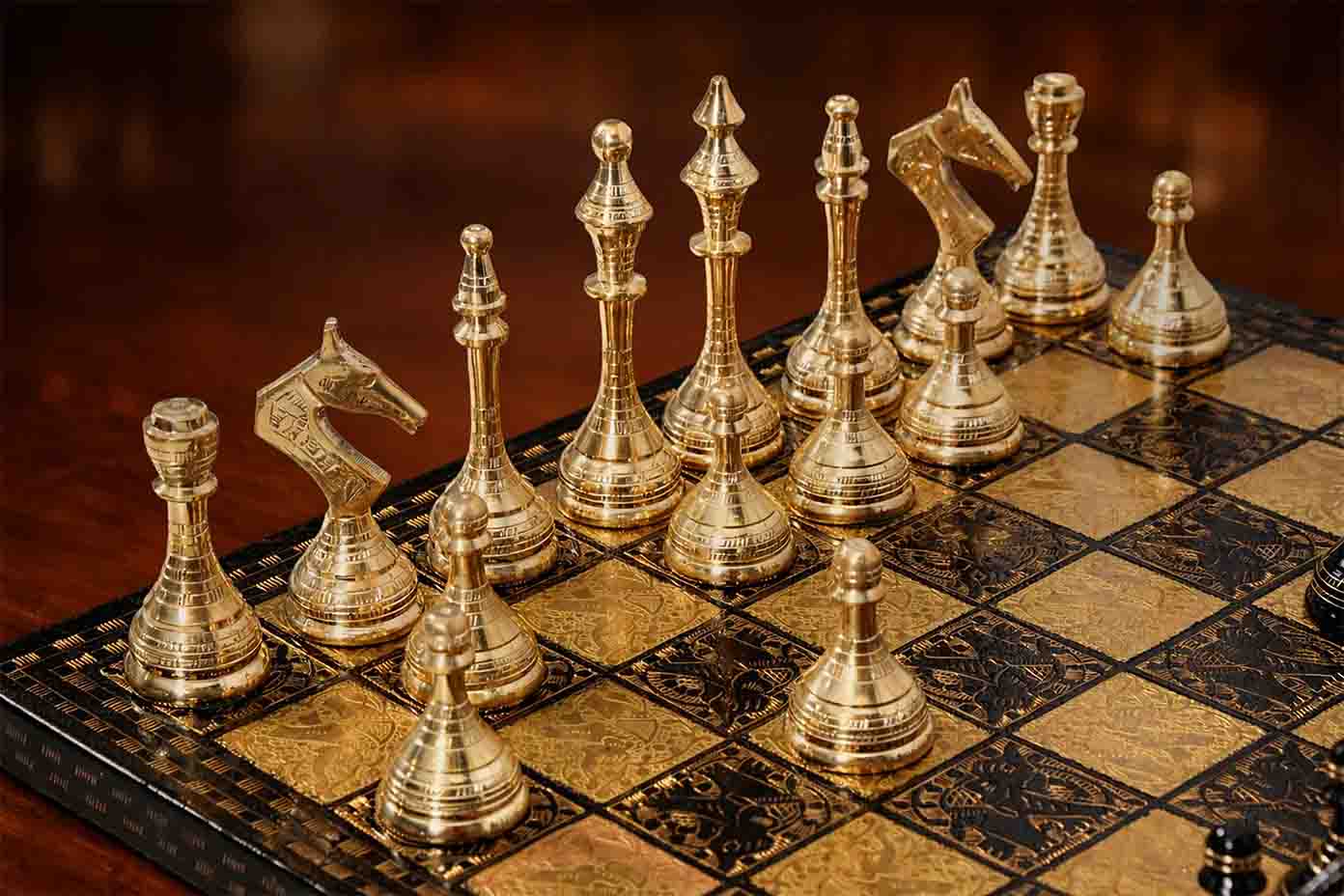 Gold and black brass Staunton chess pieces on 40mm squares