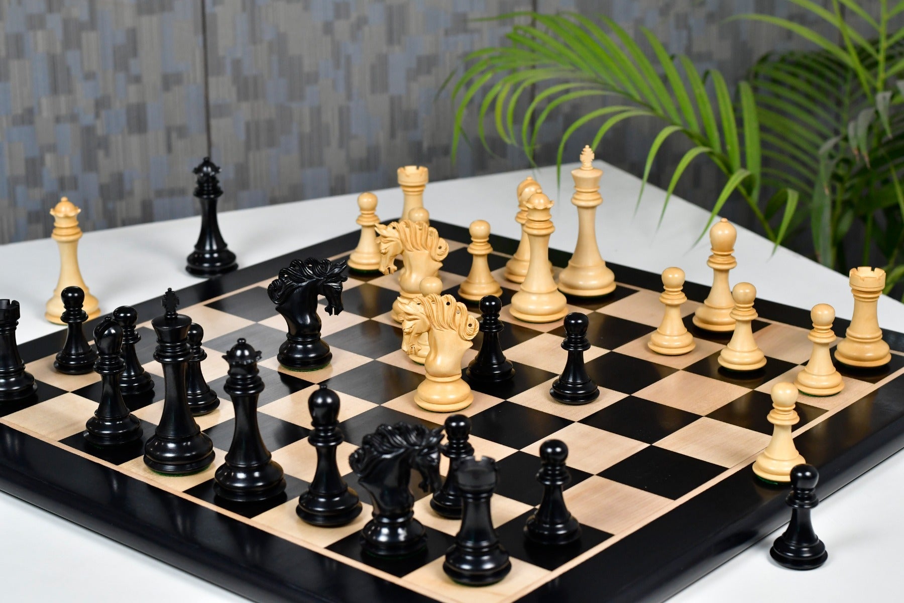 Genuine ebony chess pieces set up for play on the included 58cm solid ebony and maple board