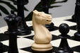 Tournament plastic chess set with the board rolled for transport