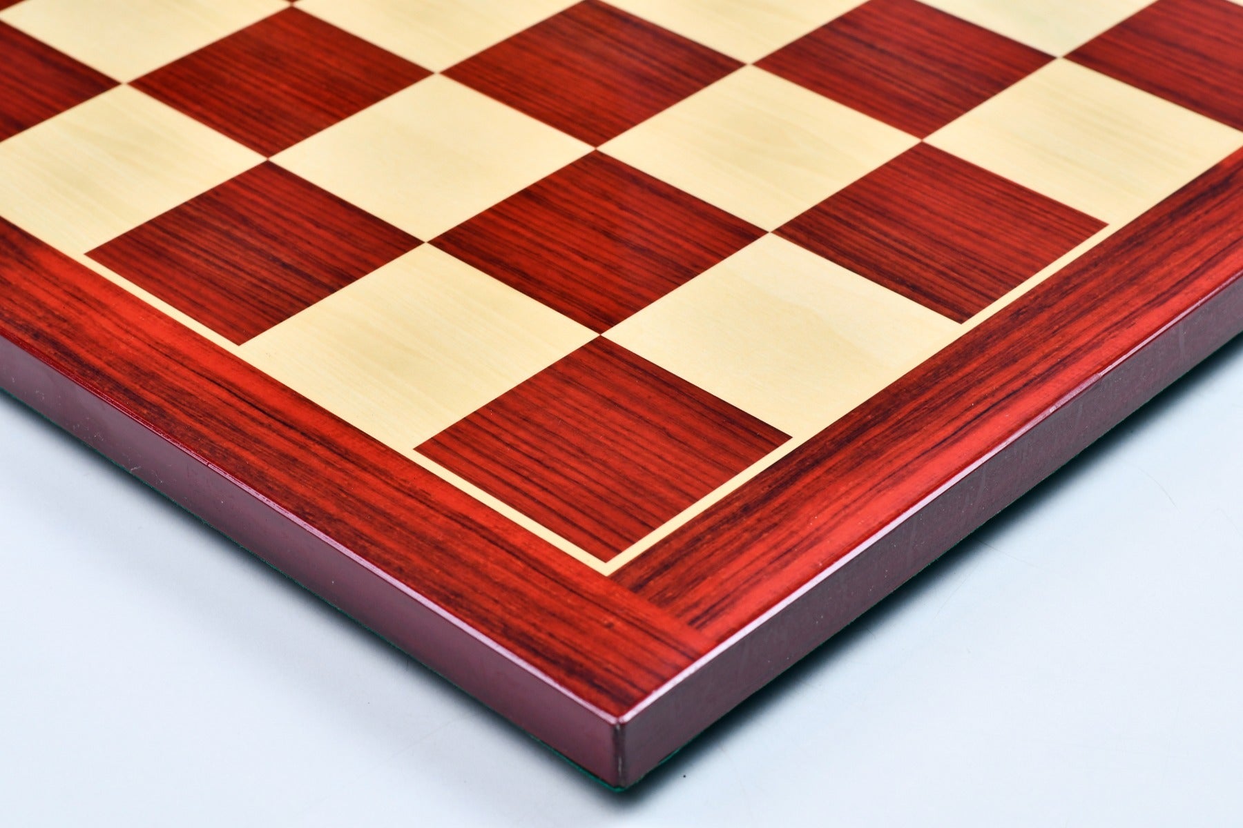 Rosewood grain chess board showing its 19mm thickness