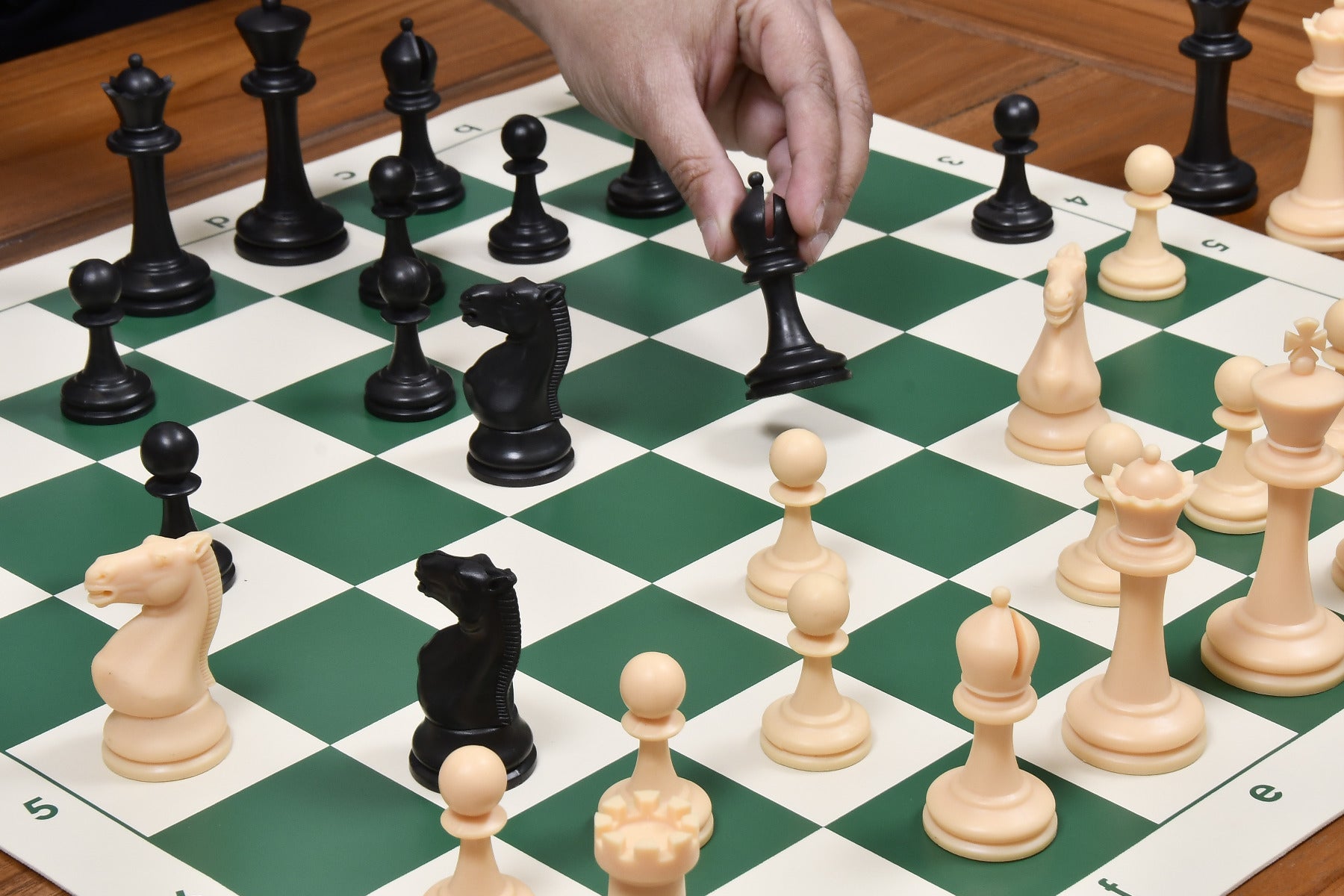 Natural white and black plastic chess pieces with a 97mm king
