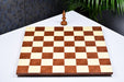 Minimalist red ash burl and maple chess board at an angle