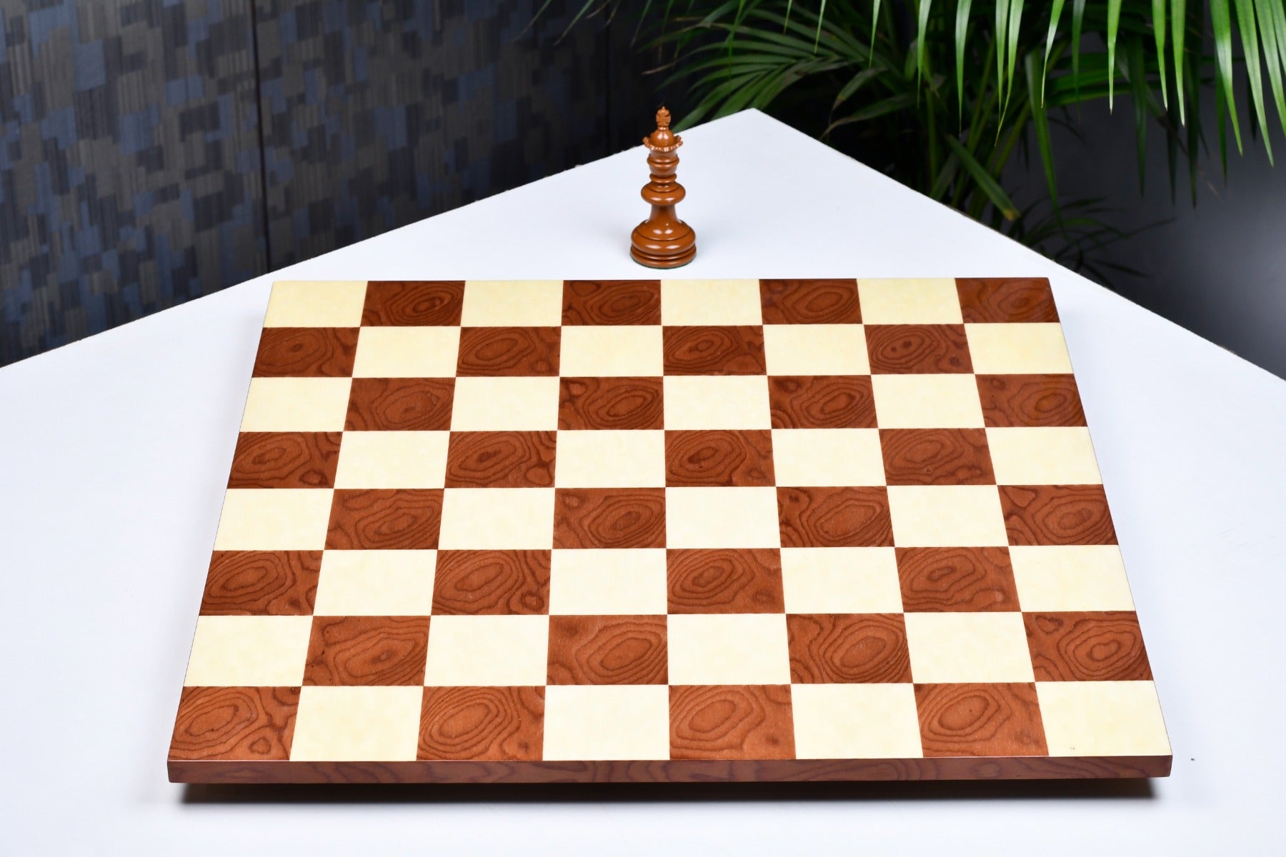 Minimalist red ash burl and maple chess board at an angle
