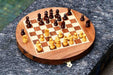 Travel chess set folded into its semicircular closed form