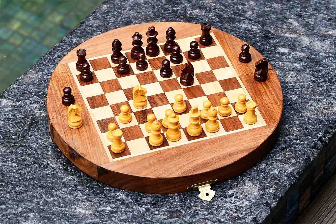 Travel chess set folded into its semicircular closed form