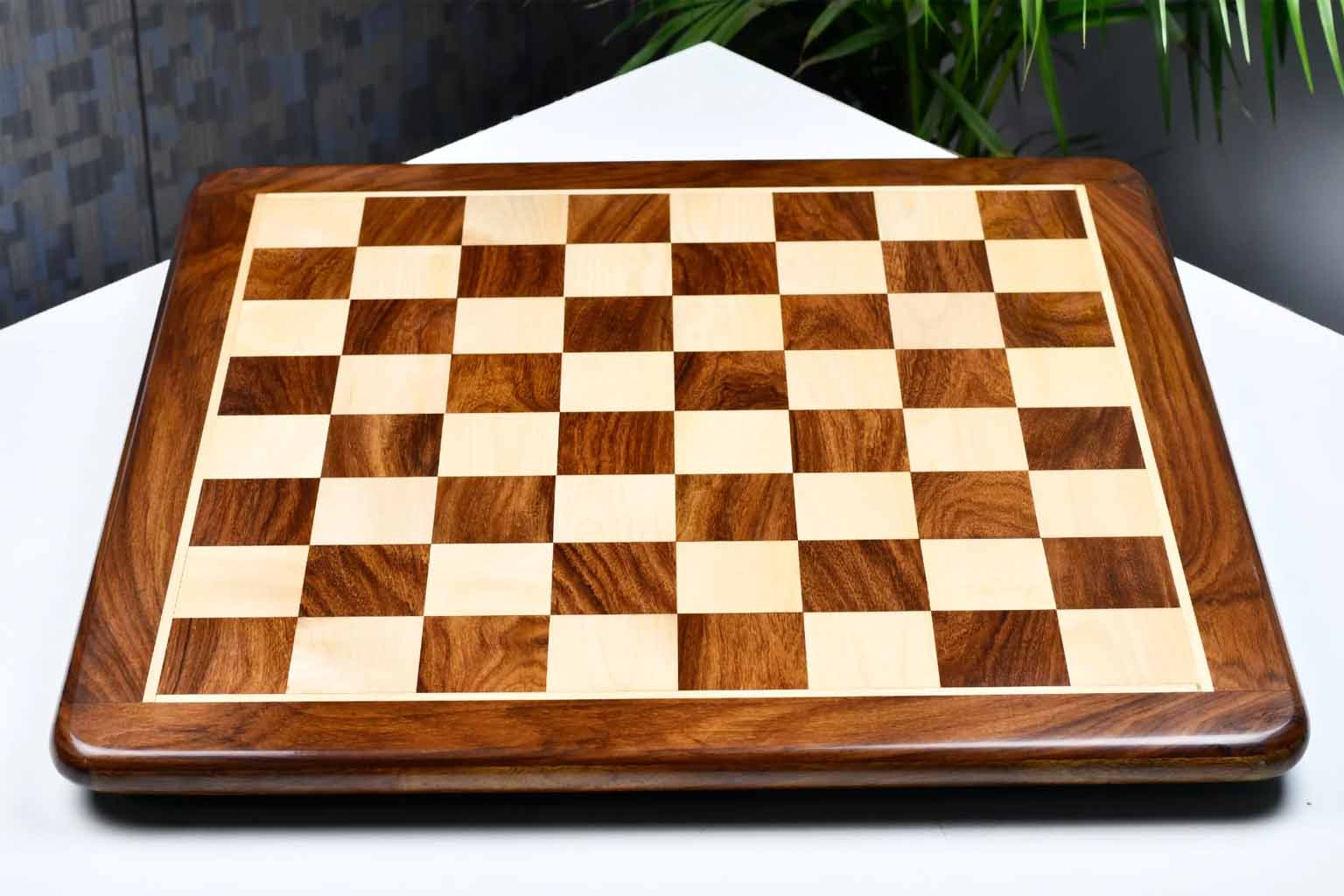 Sheesham and maple 60mm square chess board at an angle