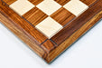 Sheesham and maple hi-gloss chess board photographed from above