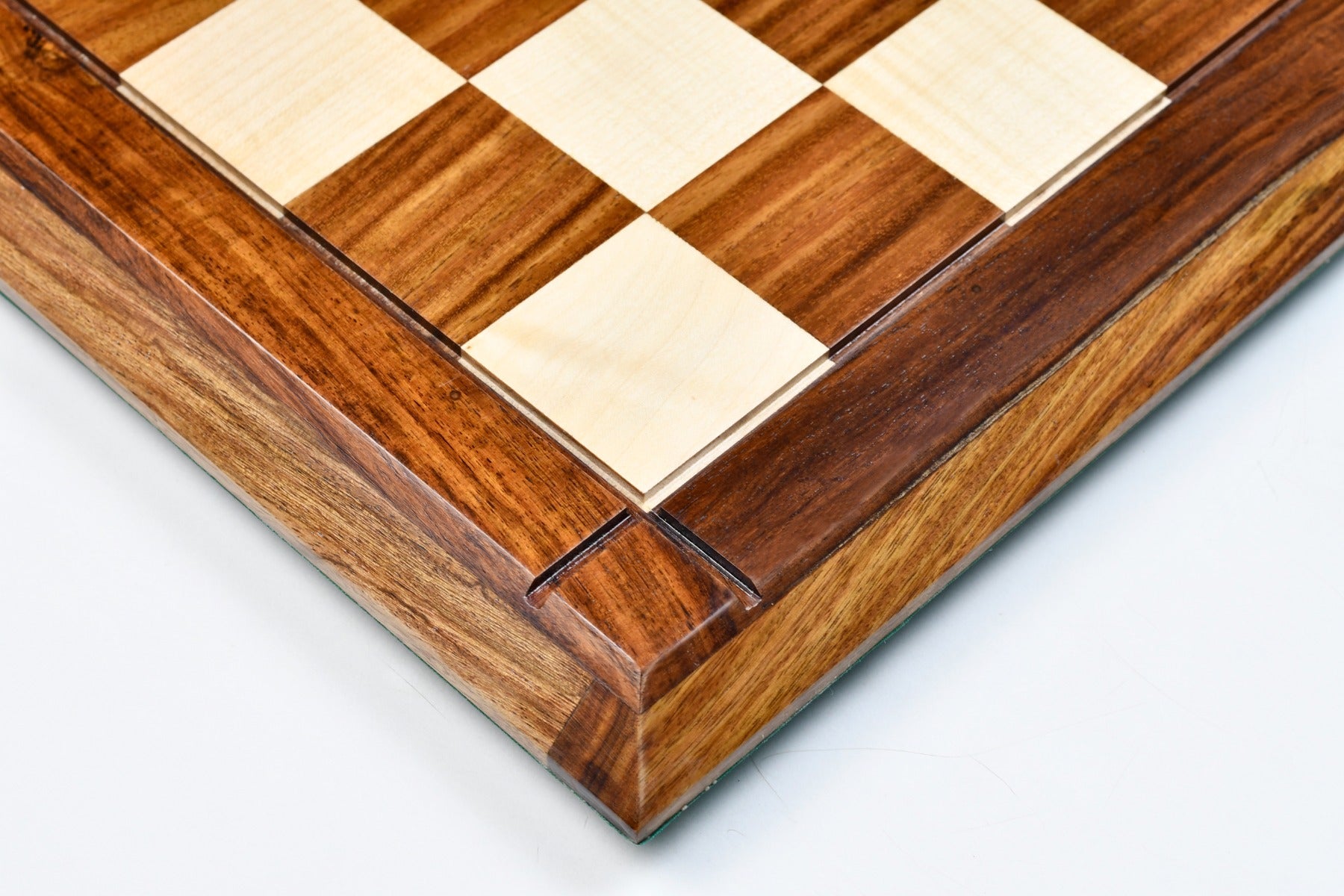 Sheesham and maple hi-gloss chess board photographed from above