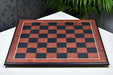 Black anigre and red ash burl chess board photographed from above
