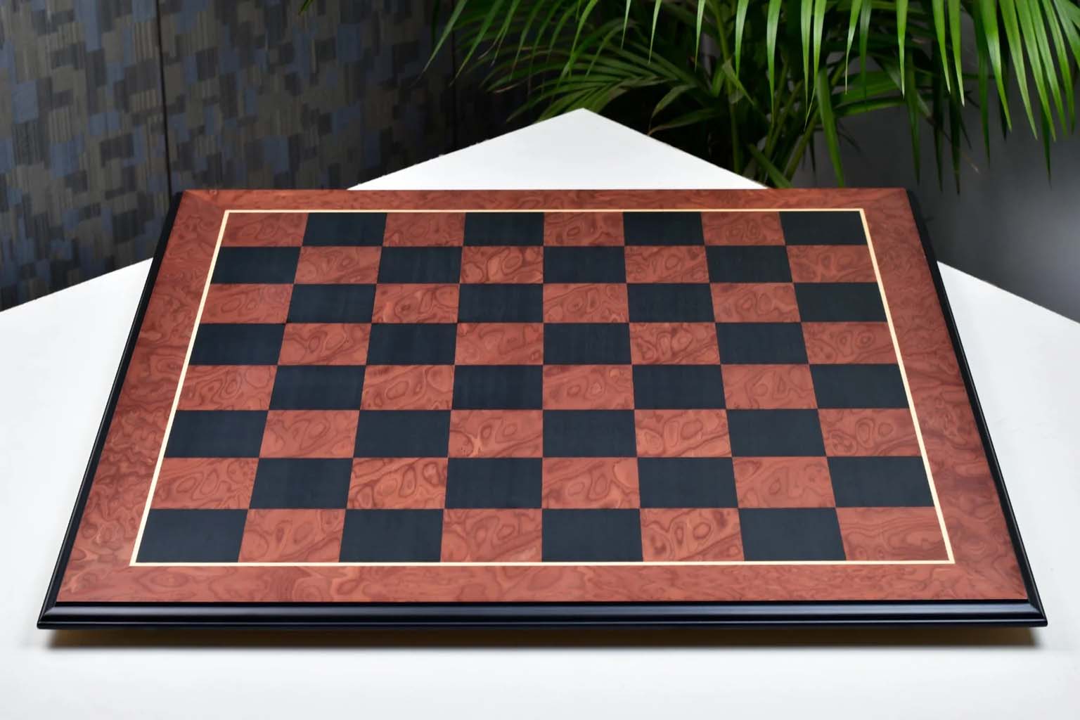 Black anigre and red ash burl chess board photographed from above