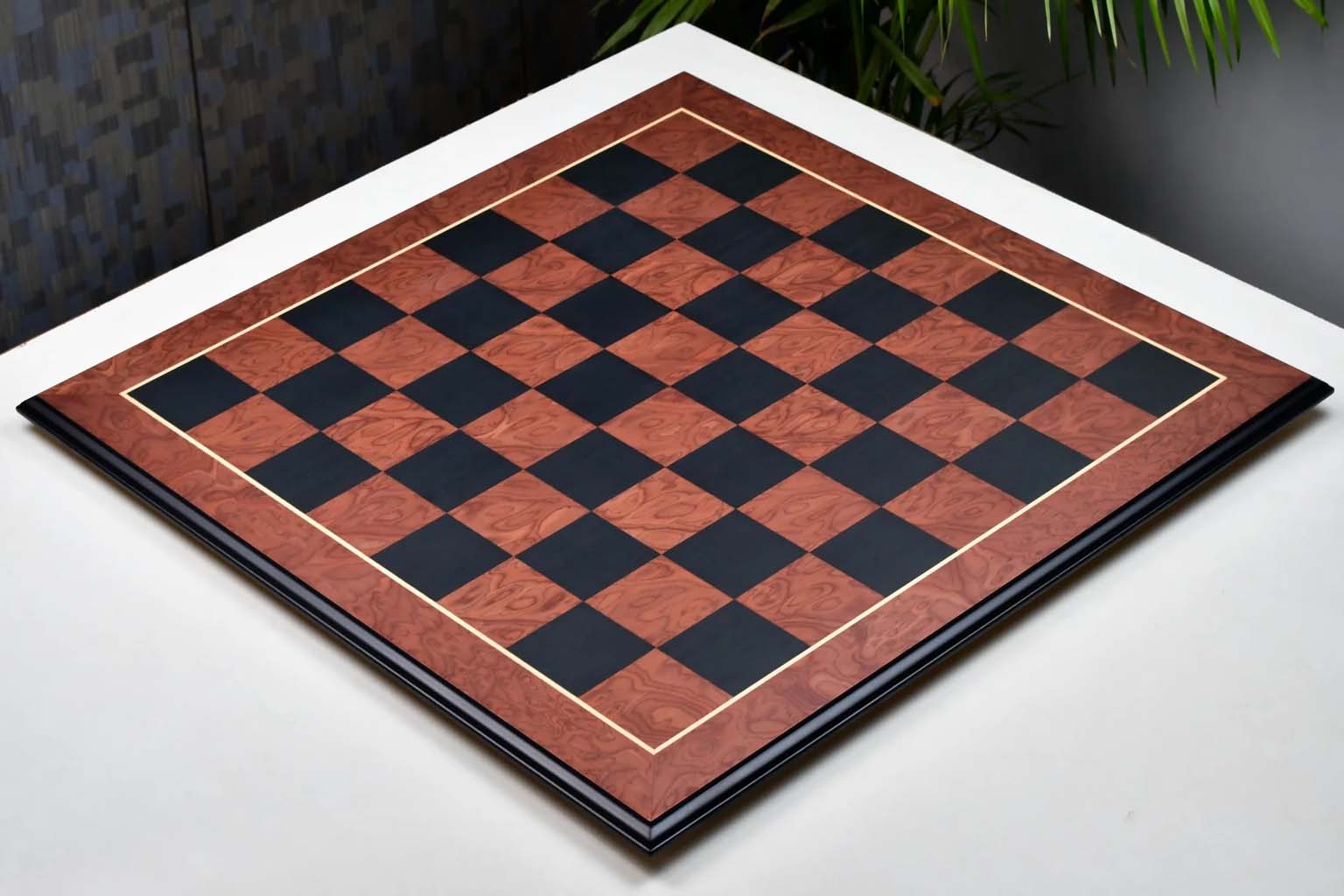 Black anigre and red ash burl chess board with moulded edges, 60cm