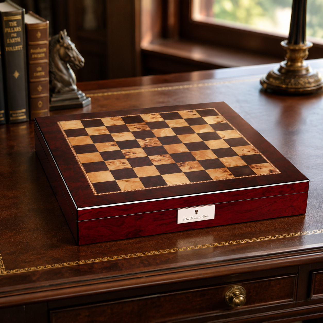 Dal Rossi mahogany finish chess box on a desk beside leather-bound books