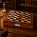 Dal Rossi walnut finish chess box on a leather-topped desk