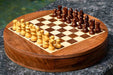 Round sheesham and maple travel chess set in playing position
