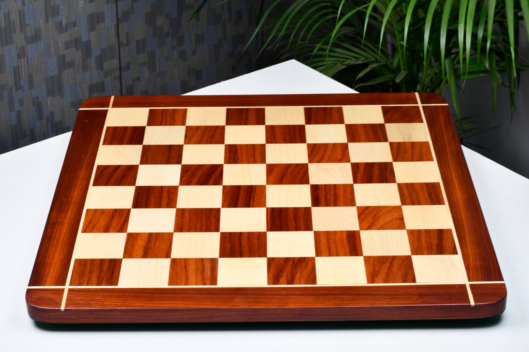 Rounded edge bud rosewood and maple 23 inch chess board at an angle