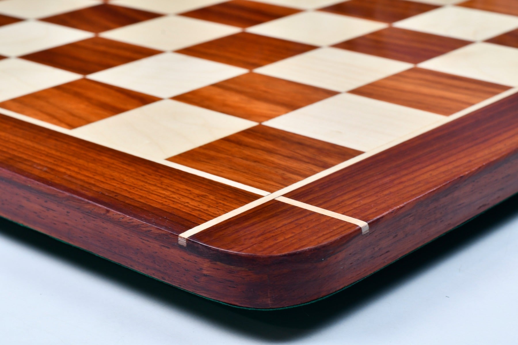 Rounded edge bud rosewood and maple chess board photographed from above