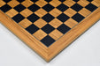 Black dyed poplar and olive chess board photographed from above
