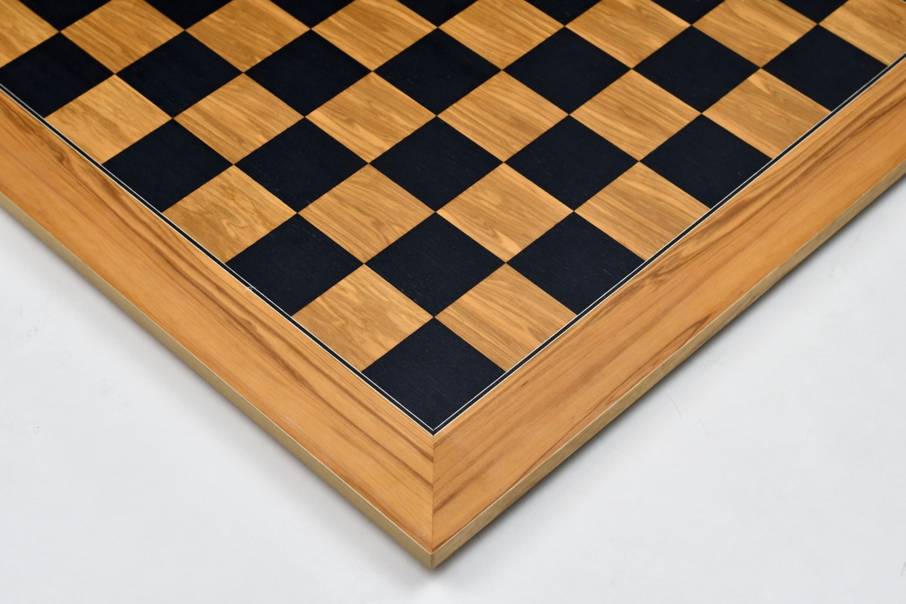 Black dyed poplar and olive chess board photographed from above